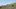 Concrete Land film image; person sitting on a grassy hill