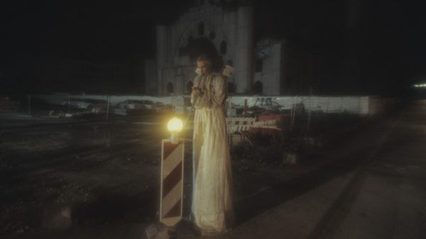 Cul-De-Sac ! film image; man standing at night beside a light