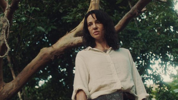 Death Has No Master film image; woman standing under a tree
