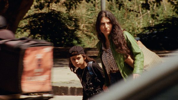 Faux Bijoux film image; woman and child crossing a street