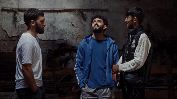 A Fire There film image; three guys looking up