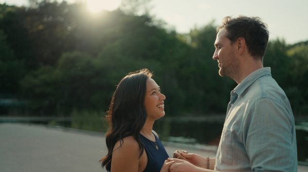 First Comes Love film image; woman and man clasping hands