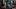 Heysel 85 film image; woman walking past crowd of injured people
