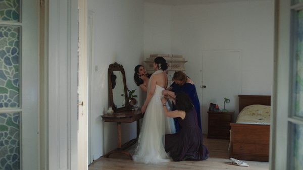 I Plant My Hand in the Garden film image; woman getting fitted into a wedding dress