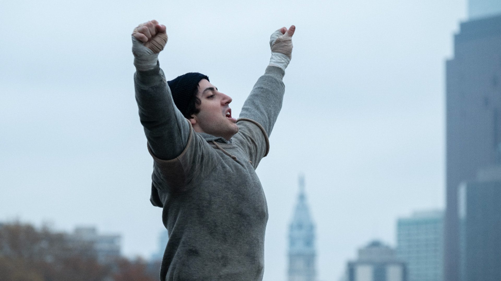 I Play Rocky film image; person holding their hands above their head in triumph