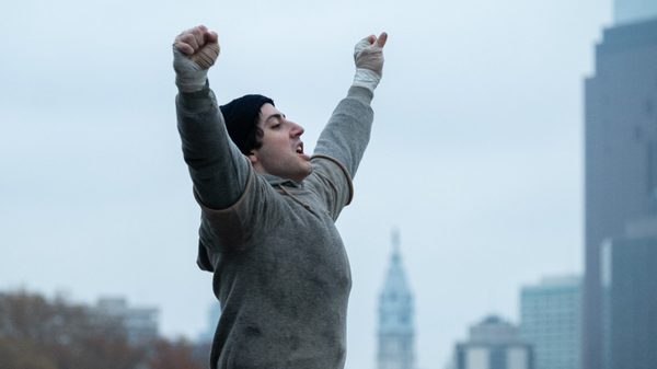 I Play Rocky film image; person holding their hands above their head in triumph
