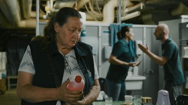 I Understand Your Displeasure film image; woman standing in a locker room