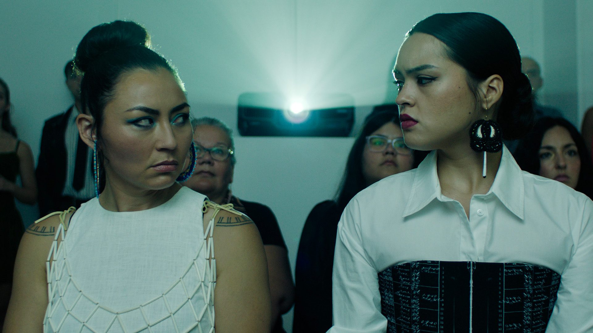 In the Heart of the South film image; two women looking at one another with a projector between them