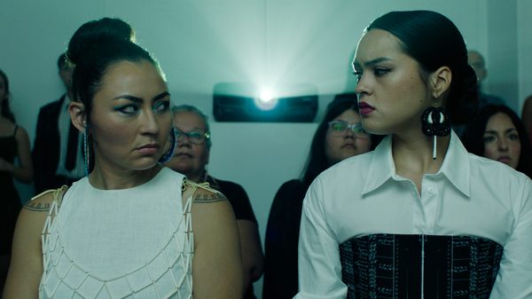 In the Heart of the South film image; two women looking at one another with a projector between them