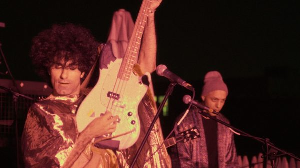 Into the Jaws of the Ogre film image; man playing a guitar