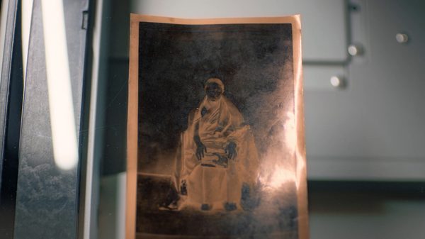 Letters From Tibet film image; photograph of a woman holding a baby