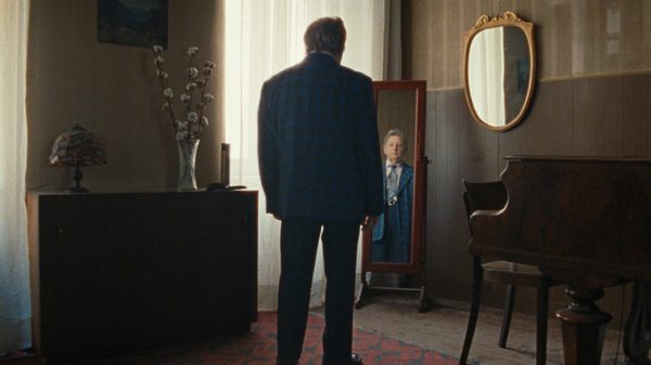 The Loneliest Man in Town film image; man looking at himself in a mirror