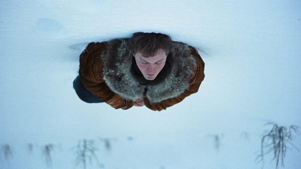A Long Winter film image; upside down shot of someone lying in the snow