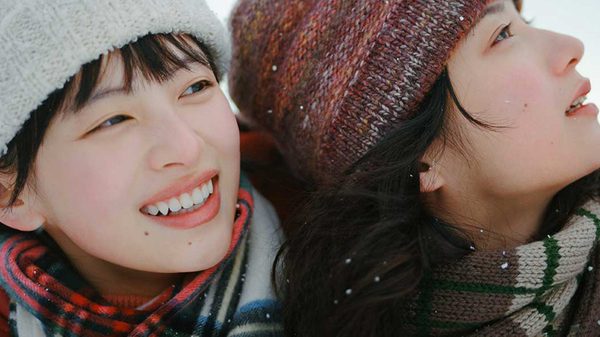 Look Back film image; two women in toques laughing