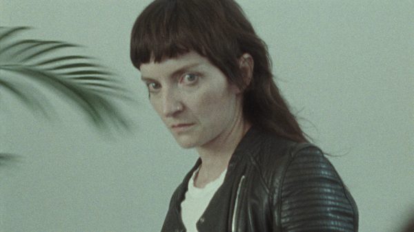 Nobody's Violence film image; woman looking wide-eyed at something
