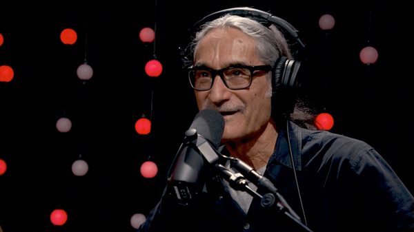 Radioheart film image; man in headphones speaking into a microphone
