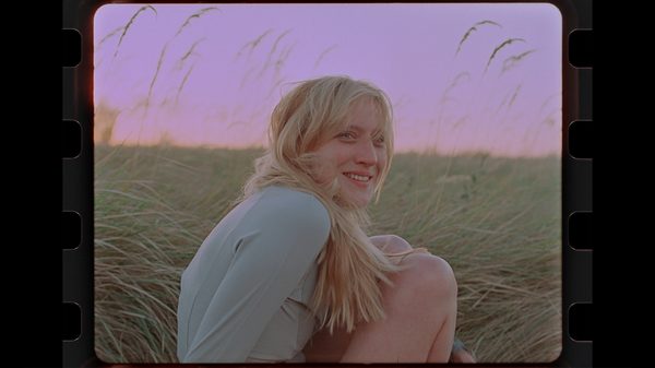 Rotation film image; woman crouched in a field
