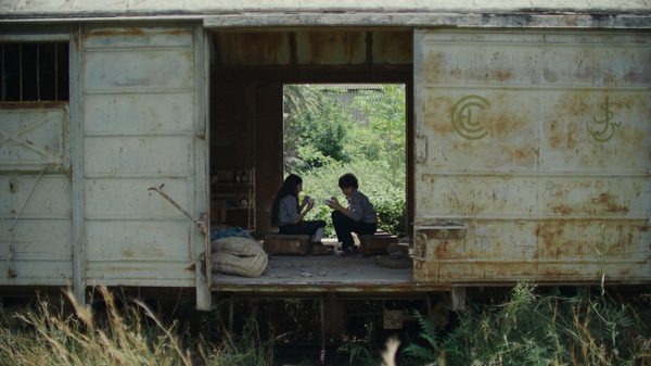 A Sad and Beautiful World film image; two people in a shelter