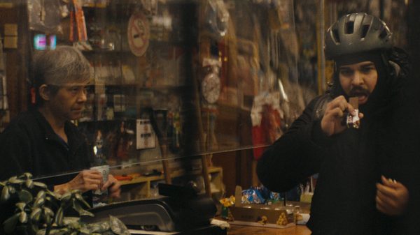 Shoot the Messenger film image; man buying something from a convenience store