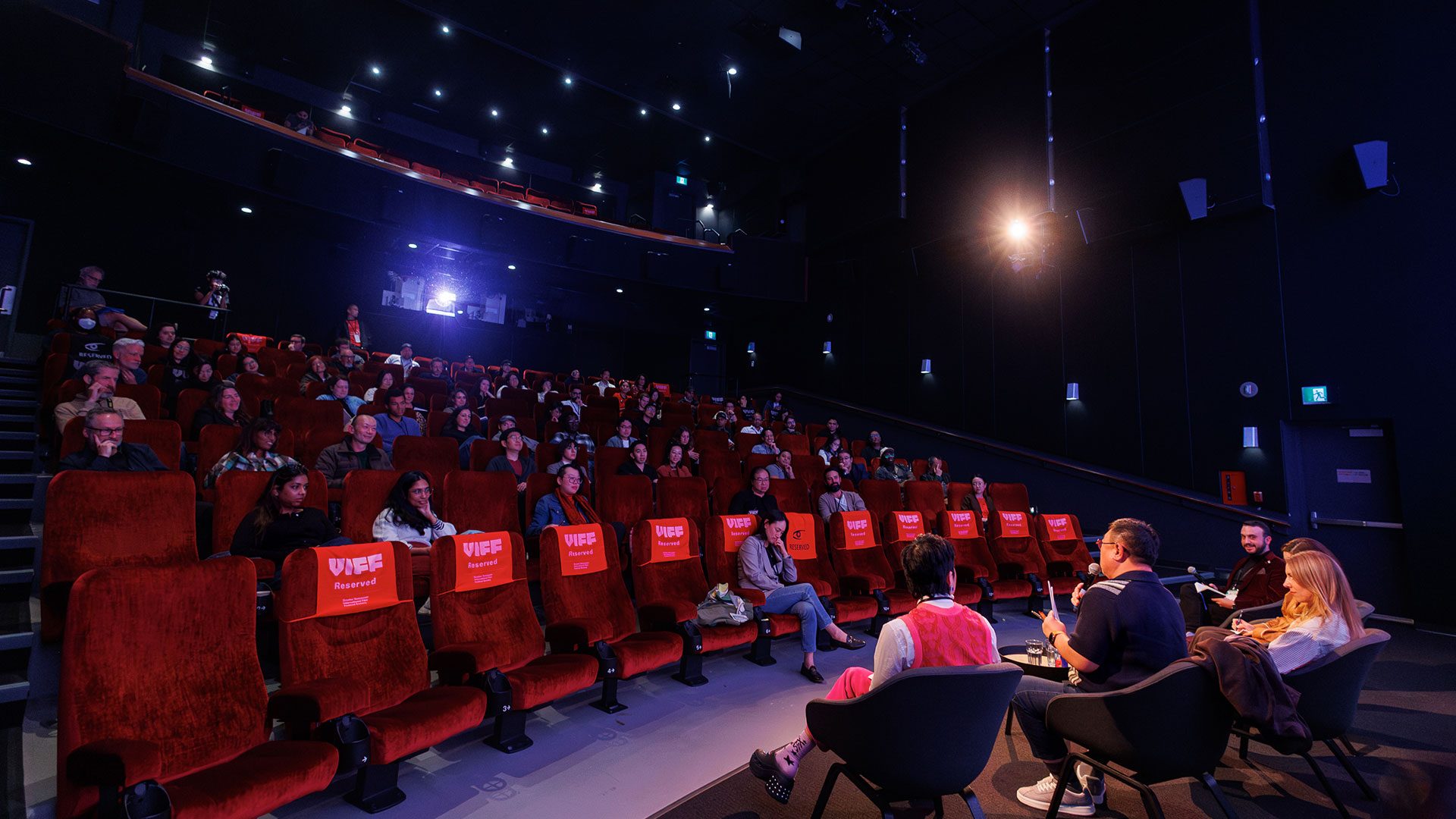 people on stage speaking to an audience