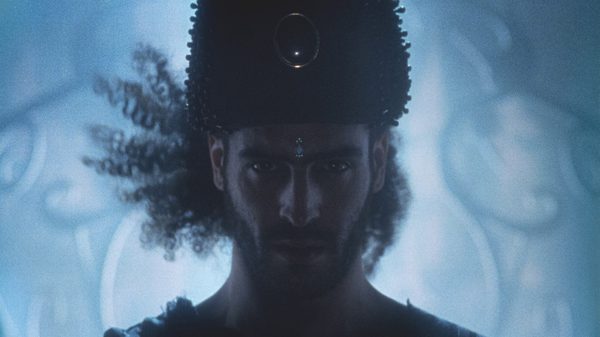 Stallion and a Crystal Ball film image; intense man backlit by white light
