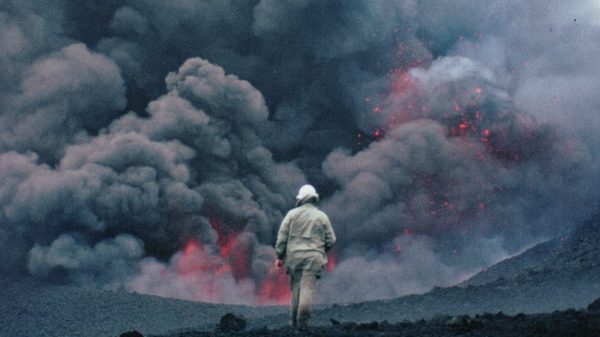 The Story of Documentary Film film image; man walking into a black smoking battleground