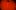 Tristesse film image; woman lying under a red spotlight