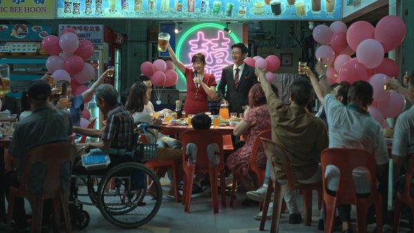We Are All Strangers film image; people gathered around a table