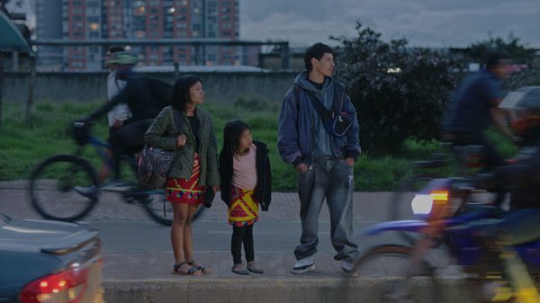 Where the River Begins film image; three people looking to cross a street
