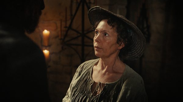Wicker film image; woman looking up at a figure just off screen