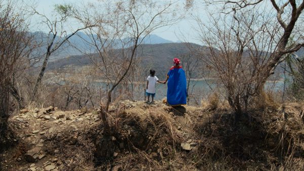 The Wind's Thirst film image; mother and child holding hands overlooking a lake
