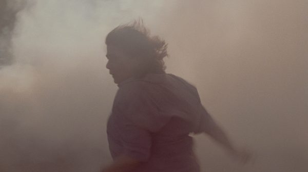 Atonement film image; person running through smoke