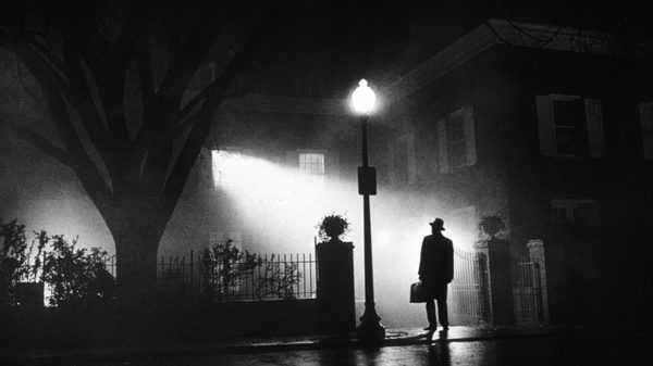 The Exorcist film image; silhouetted figure standing outside a house at night
