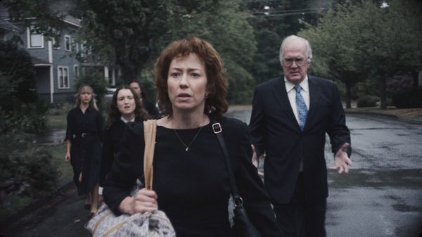 The Liberation film image; woman leading a group of people down a street