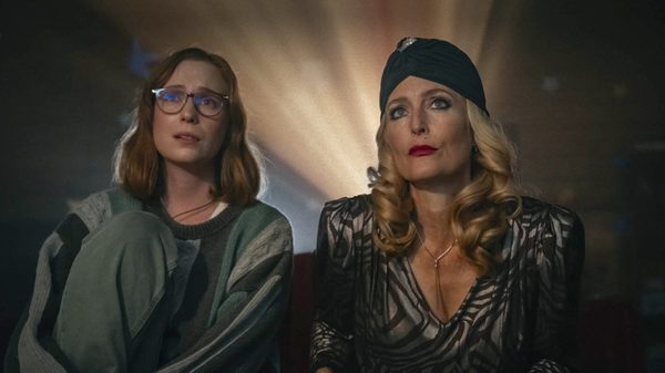 two women with a projector light shining over their shoulders