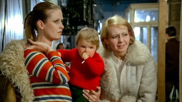 Everything For Sale film image; woman carrying a baby