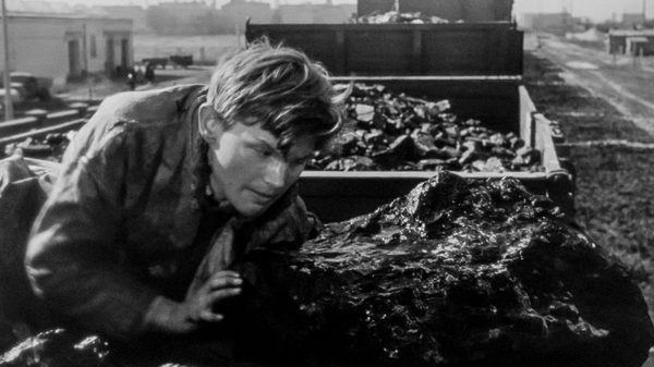 A Generation film image; man hunched on the ground