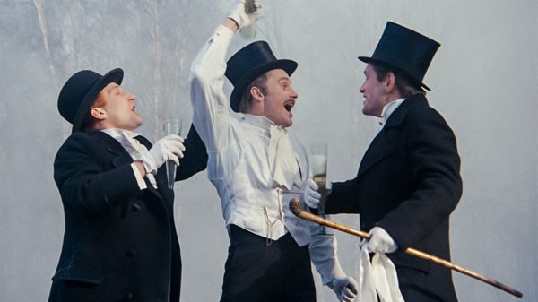 The Promised Land film image; men in tuxedos gesturing at one another