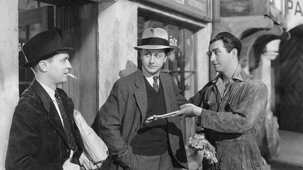 Three Comrades film image; men gathered outside chatting